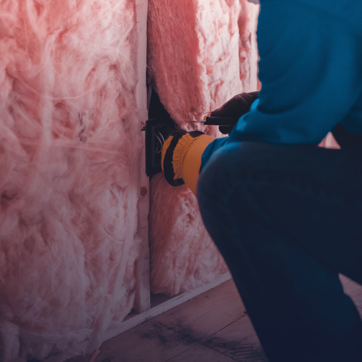 A person maintaining insulation in a wall