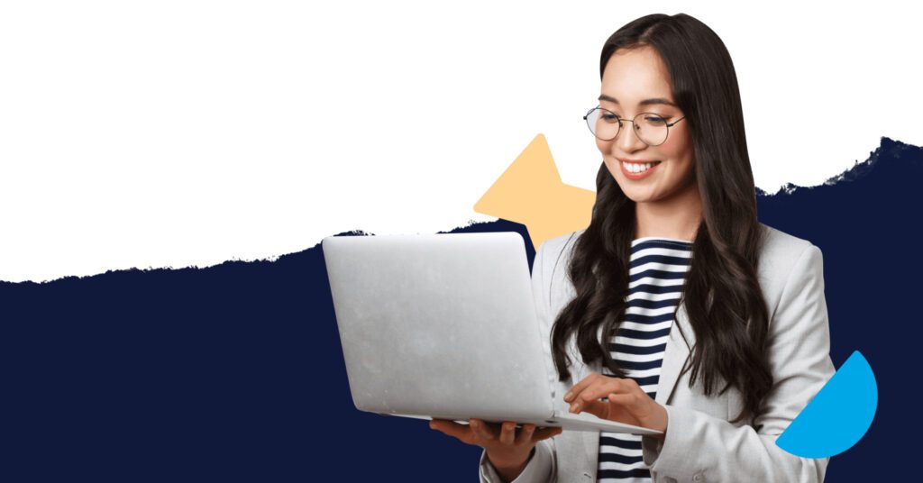 Young asian woman standing holding her laptop and typing