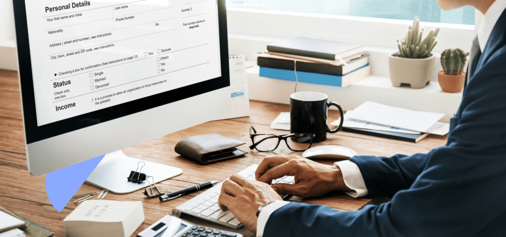A close-up of a person typing and reviewing British Columbia rental agreements and documents.