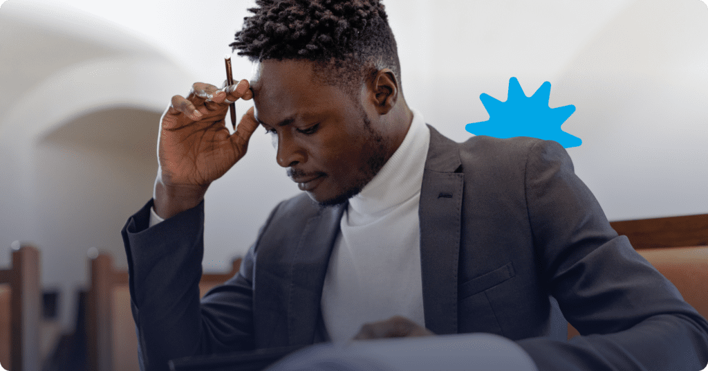 A person sitting at a desk and thinking about tenant screening platforms.
