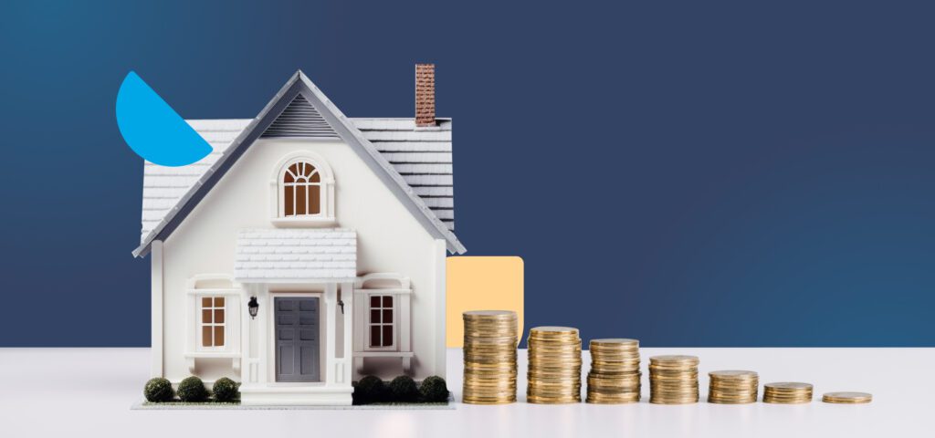 A white-painted home with stacks of coins decreasing in size beside it